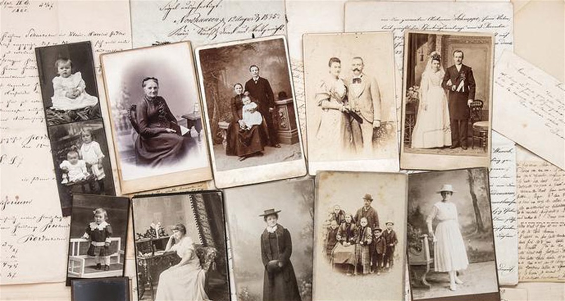 Picture of a collection of historical family photrographs and hand written documents. 