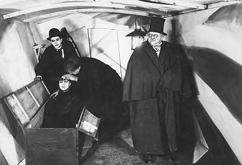 Scene from from the horror movie The Cabinet of Dr Caligari, showing Dr Caligari, a man and Cesare in the cabinet. 