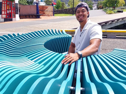 Ryan Peralta poses with his award-winning seat at the Town Basin. 