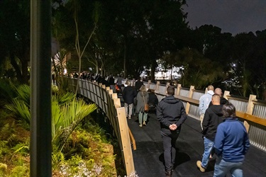 Guests walk across Lovers Lane Bridge the dawn opening.