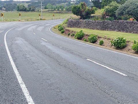 A bend in the road with stripped chips from the road seal. 