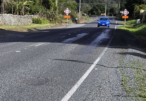 A photo of a road with loose road seal.