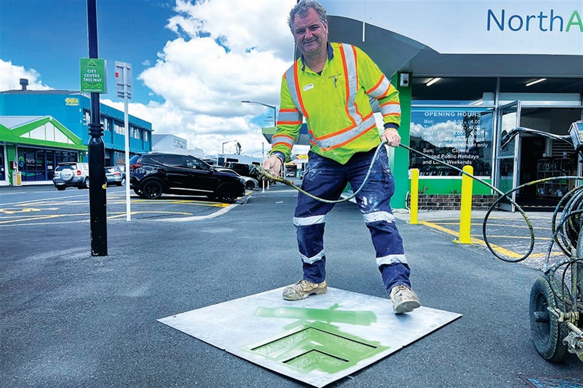 Mike Dunbar from Coastline Markers installs signs and wayfinding stencils showing cruise ship visitors the way into the city centre.