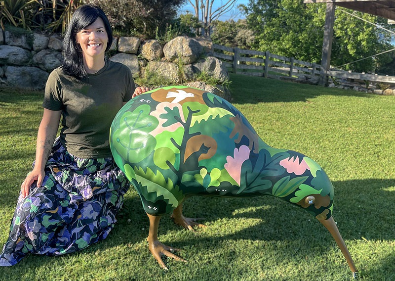 Briar van Ameringen poses with with her Night Watcher kiwi sculpture. 