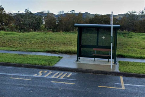 A photo of a bus shelter and bus stop. 