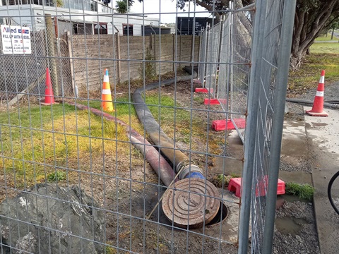 A photo of pipes coming out of a manhole.