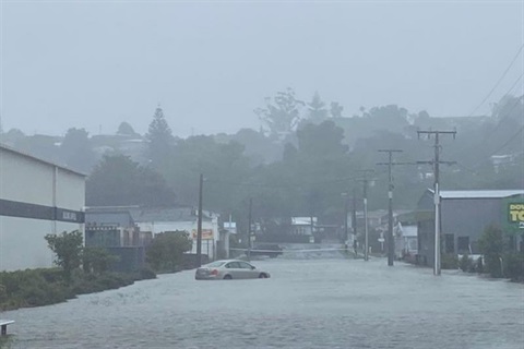 A photo of a car trapped in flood waters on a street in Morningside. 