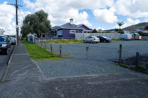 Image of empty property lot with cars parked on it. 