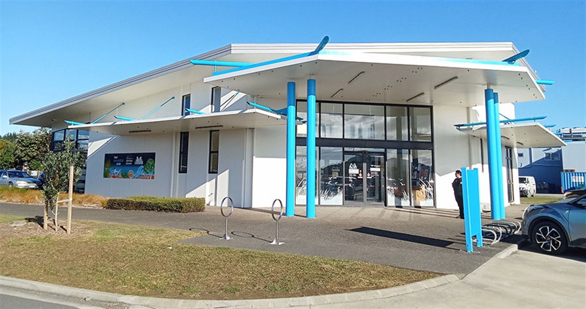 An outdoor photograph of the exterior of the Ruakākā Service Centre building with a blue sky.