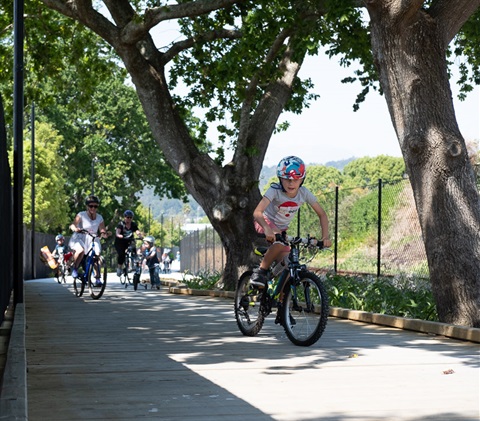 Photo showing people using bikes on a shared path. 