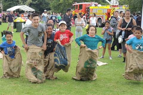 Photo of children in a sack race. 