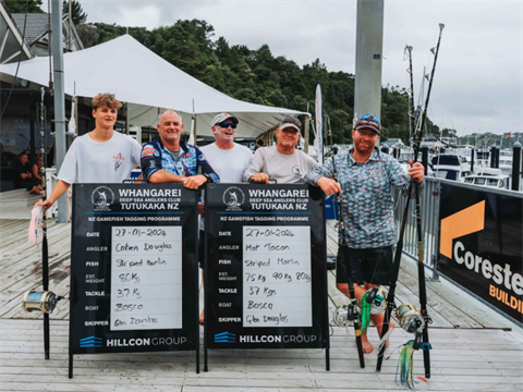 Image of five men on the dock with the fish they caught. 