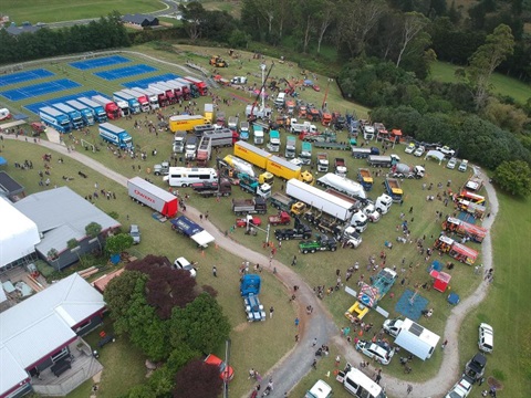 Image of a birds eye view of the trucks parked on the field. 