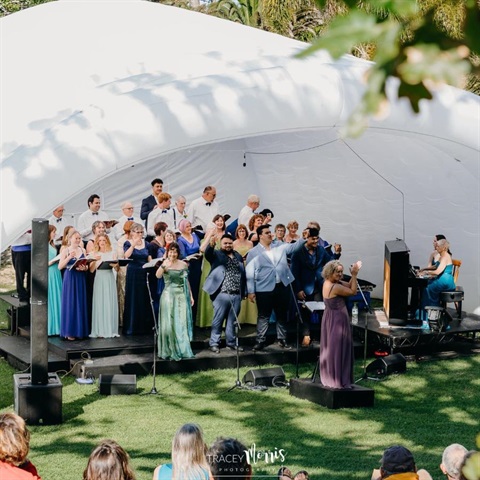 Image of opera singers under the blow up stage. 