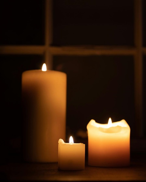 Image of three lit candles. 