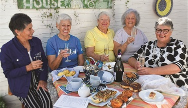 Older adults enjoying a leisurely chat during a Silver Festival event.