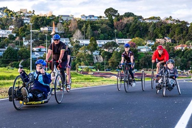 Various riders on adaptive bikes on Bike Park Circuit track at Pohe Island.