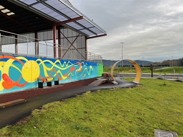 Mural and tunnel on beginner skills track at Bike Park on Pohe Island. The colourful mural next to the beginners area was created by artist Lucinda Skye.