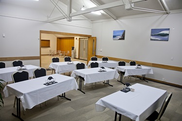 Bounty Room classroom layout, corner angle with chairs and tables setup facing one table.