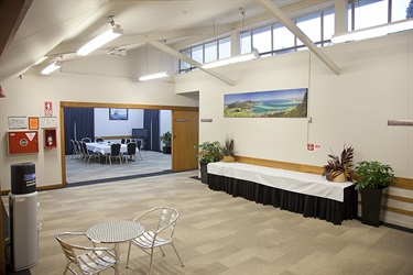 Bounty Room outside kitchen area with buffet table and plants setup on each side.