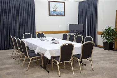 Bounty Room in a meeting layout with tables and chairs setup.