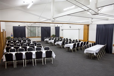 Cafler Suite setup in a banquet layout with tables and chairs in a well-lit room.