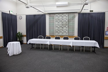 Cafler Suite front stage banquet layout, with tables and chairs setup.