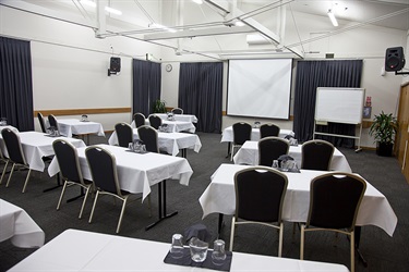 Cafler Suite classroom layout with chairs and tables setup in a well-lit room.