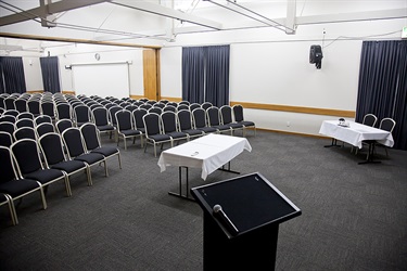 Cafler Suite theatre layout with chairs and lectern setup, lectern view.