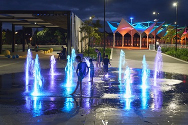 Kids enjoying water play at night