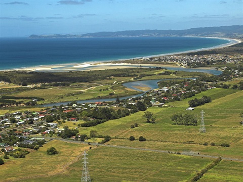 Aerial photo of Ruakaka and Bream Bay farmland, houses and beach. 