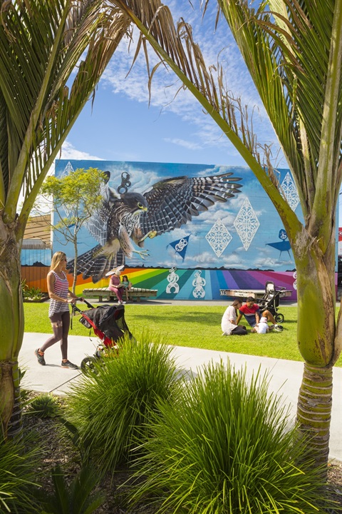 Woman with pushchair walking through the Pocket Park.