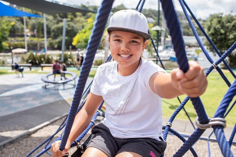 Photo of girl playing at playground. 