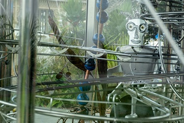 The robot pedal man sits inside of the rolling ball clock.