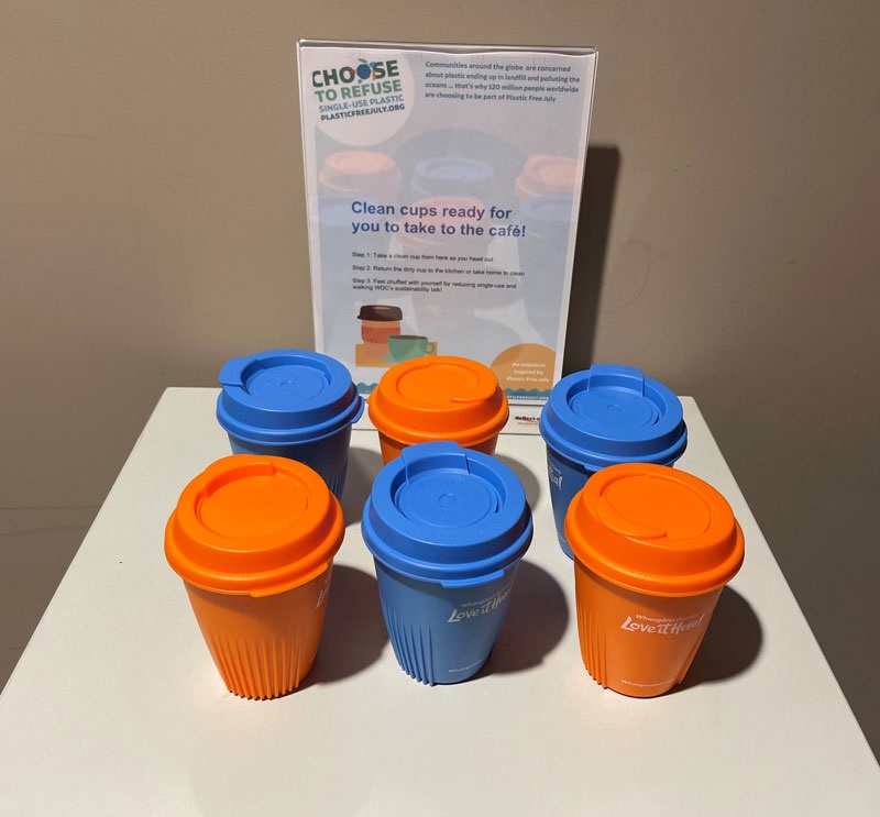 An image showing orange and blue reusable plastic coffee cups. 