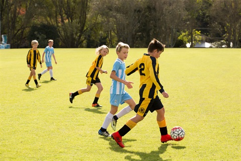 Photo of children playing football at Pohe Island. . 