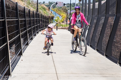 A woman and child riding on the Kamo Shared Path. 