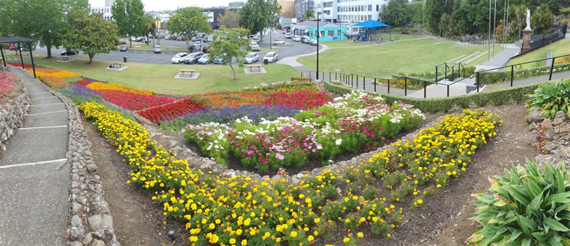 Image showing Laurie Hall Park gardens, flowers, memorial, playground and car park. 